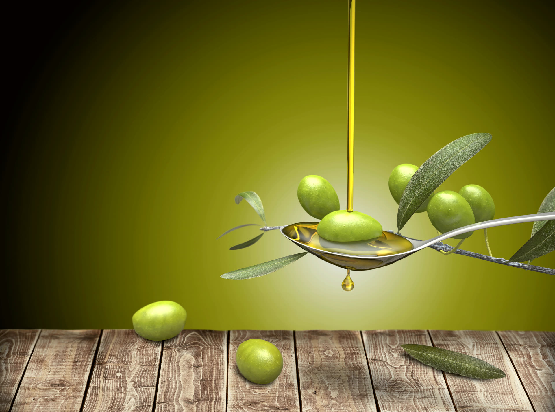 Olive oil pouring from a bottle.